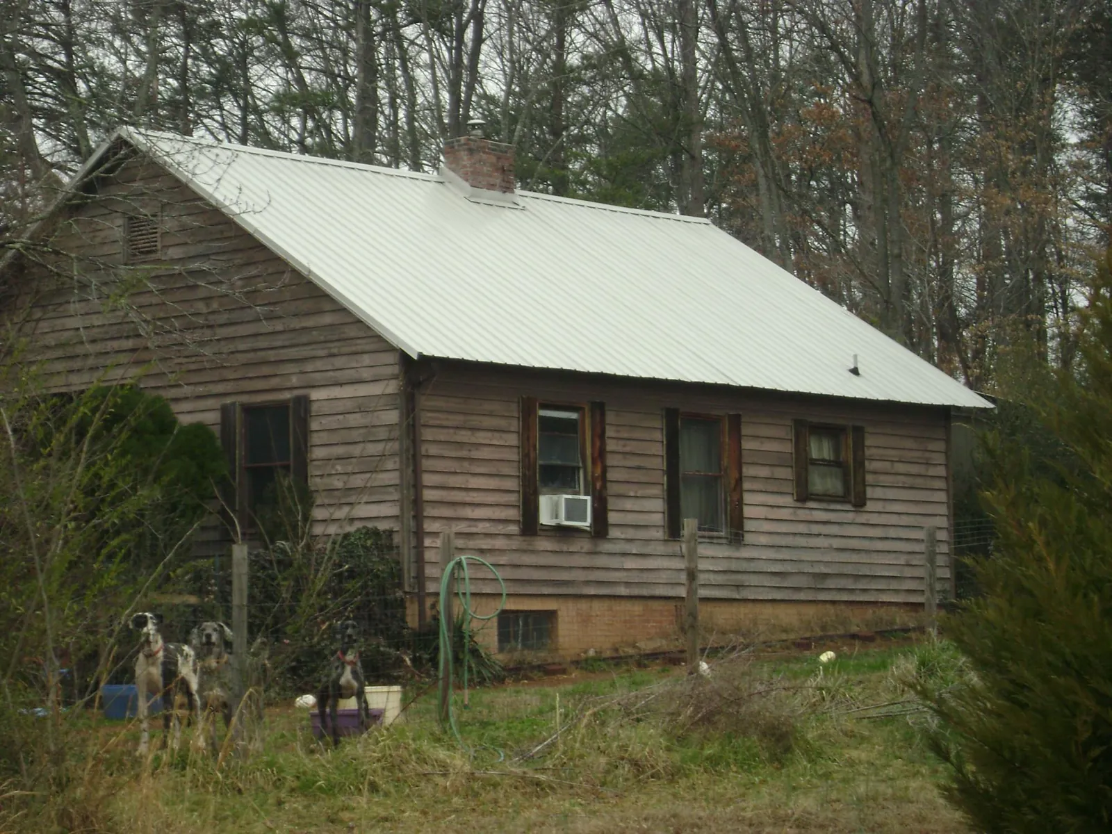 White metal roof on an old wood sided farmhouse, from a Metal Roof Installation job in Orwell